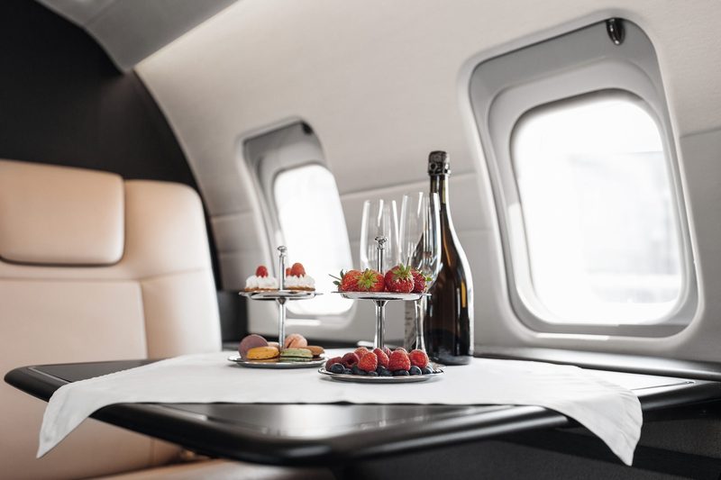 Business jet cabin with a table set for service